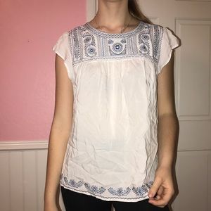 White blouse with blue stitching